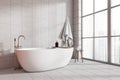 Corner view on bright bathroom interior with bathtub, panoramic window Royalty Free Stock Photo
