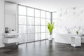 Corner view on bright bathroom interior with white bathtub, sink Royalty Free Stock Photo