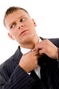 Corner view of businessman tucking his button