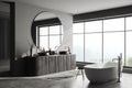 Corner view on dark bathroom interior with bathtub, panoramic window Royalty Free Stock Photo