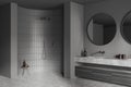 Corner view on dark bathroom interior with large round mirrors Royalty Free Stock Photo