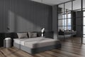 Corner view on dark bedroom and bathroom interior with bed Royalty Free Stock Photo