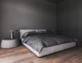 Corner view on dark bedroom interior with bed. Empty grey wall and wardrobe, bedside. Hardwood floor. Concept of Royalty Free Stock Photo