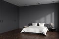 Corner view on dark bedroom interior with empty grey wall Royalty Free Stock Photo