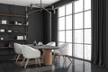 Corner view on dark kitchen interior with dining table, window