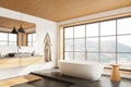 Modern hotel bathroom interior with sink, tub and panoramic window Royalty Free Stock Photo