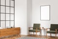 Corner view of living room with canvas on white wall and armchairs Royalty Free Stock Photo