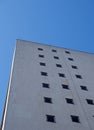 Corner view of an old white 1960s concrete office block against a blue sky Royalty Free Stock Photo