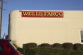 Corner view Wells Fargo bank sign with blue sky and car