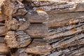 Corner of the wall of a very old log house, wooden background. Royalty Free Stock Photo