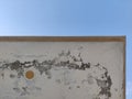 Corner of a weathered white building against a clear blue sky background view Royalty Free Stock Photo