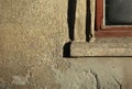 Corner of wood window with fiber texture with red frame and glass. Window sill, wall and edging gray cement plaster with yellow Royalty Free Stock Photo