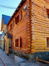 Corner of wooden facade of mountain houses in polar climates. Rustic high mountain constructions. Architecture in cold climates