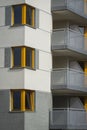 Corner yellow wooden windows in multi family house Royalty Free Stock Photo