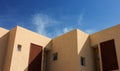 Corners and lines geometric shapes of concrete small building apartment foreshortening from below with blue sky background