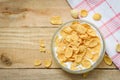 Cornflakes in bowl with milk wooden background for cereal healthy food breakfast Royalty Free Stock Photo