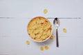 Cornflakes breakfast in bowl and spoon on wooden background - cereal healthy food