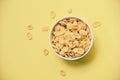 Cornflakes breakfast in bowl on yellow background for cereal healthy food