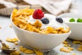 Cornflakes. Dish of cornflakes with yogurt blueberries and raspberries on kitchen table