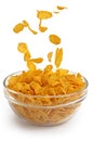 Cornflakes falling into a glass bowl