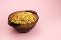 Cornflakes in a glass plate on a pink background