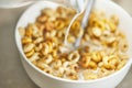 Cornflakes with milk healthy and healthy breakfast. Cornflakes in bagel shape in a white bowl Royalty Free Stock Photo