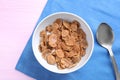 Cornflakes with milk on pink wooden table. Healthy breakfast