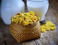 Cornflakes and milk on wood table