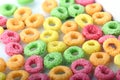 Cornflakes rings breakfast cereal with fruits on a white background Close to yellow, green and red colors Baby food is served with Royalty Free Stock Photo