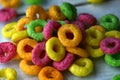 Cornflakes rings breakfast cereal with fruits on a white background Close to yellow, green and red colors Baby food is served with Royalty Free Stock Photo