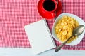 Cornflakes, strawberry, milk and a cup of coffee for breakfast