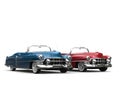 Cornflower blue and cherry red vintage cars with white wall tires - side by side Royalty Free Stock Photo