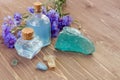 Cornflower blue essential perfume bottled water and minerals stones on wooden background