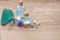 Cornflower flower blue water in glass bottles, natural stones and flowers on brown wooden background, copy space. Aromatherapy or