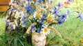 Cornflowers, chamomile and ears of wheat in a simple cute bouquet for a rustic background. A bouquet of wildflowers stands in a