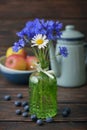 Cornflowers in vintage bottle