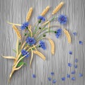 Cornflowers and wheat ears bunch on wood background Royalty Free Stock Photo