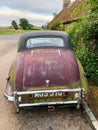 Cornhill-on-tweed, UK - 26th August 2021: Vintage Riley saloon car dirty and unloved on the roadside, rear view.