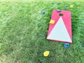 Cornhole board with bean bags on lawn Royalty Free Stock Photo