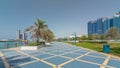 Corniche boulevard beach park along the coastline in Abu Dhabi timelapse hyperlapse with skyscrapers on background. Royalty Free Stock Photo