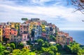 Corniglia traditional typical Italian village with colorful multicolored buildings houses on rock cliff and Genoa Gulf, Ligurian S