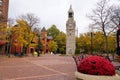 The clock tower near Gaffer District with the background of fall foliage in Corning, New York, U.S