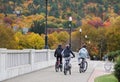 Corning, New York, U.S - October 18, 2022 - A group of kids on the bicycle riding on the Centerway Bridge with the background of Royalty Free Stock Photo