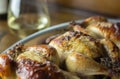 Cornish hens in an aluminum baking pan right out of the oven with crispy browned skin and crusty herbs. Royalty Free Stock Photo