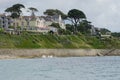 Cornish sea front, overlooking the Ocean with structures, hills to the background Royalty Free Stock Photo