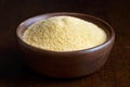 Cornmeal polenta in brown wooden bowl.