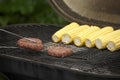 Corns and burgers on a barbeque grill. Conceptual image Royalty Free Stock Photo