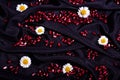 Corns of pomegrana, flowers on black silk fabric.