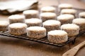 Cornstarch alfajores on a black rack.