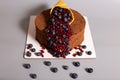 Cornucopia decoration on a cake with fresh berries. Beautiful decorat cake on grey background